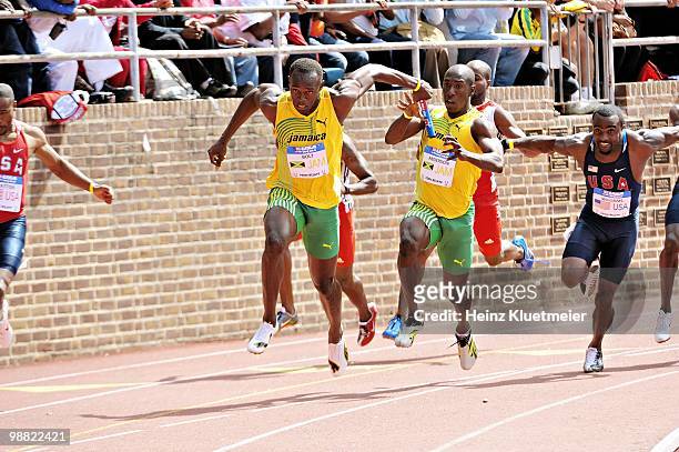116th Penn Relays: Jamaica Usain Bolt in action, taking baton from Marvin Anderson during USA vs The World 4x100M Relay at Franklin Field. Jamaica...