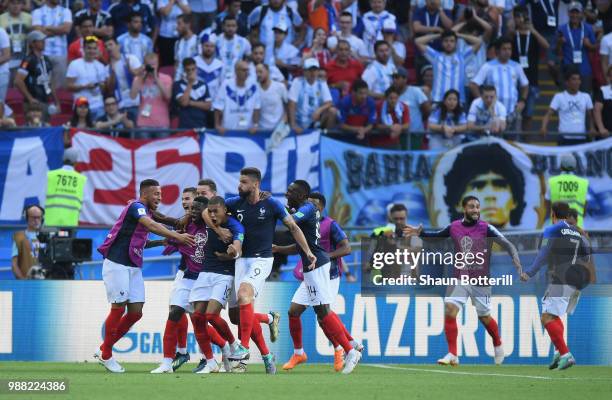 Kylian Mbappe of France is congratulated by team-mates after scoring during the 2018 FIFA World Cup Russia Round of 16 match between France and...