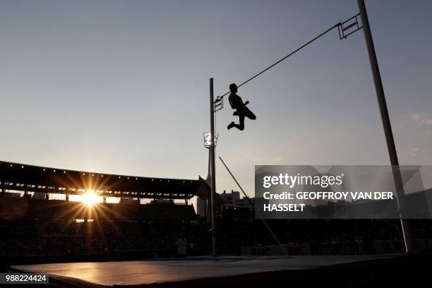 France's Renaud Lavillenie celebrates clearing 5.77m to share the lead as he competes in the men's pole vault event during the IAAF Diamond League...