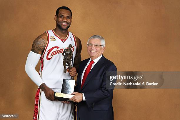 LeBron James of the Cleveland Cavaliers poses with NBA Commissioner David Stern prior to receiving the Maurice Podoloff Trophy in recognition of...