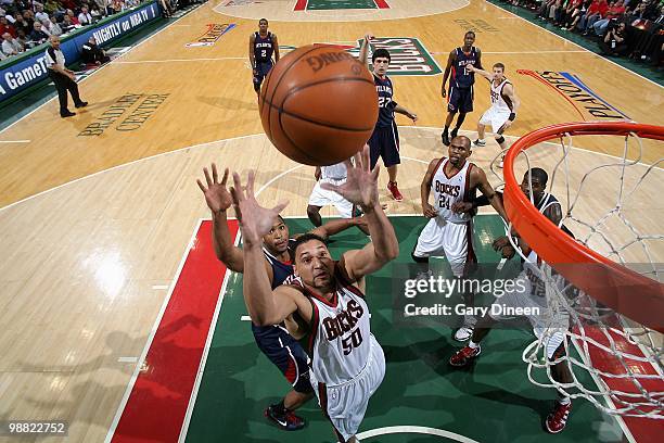 Dan Gadzuric of the Milwaukee Bucks comes down with a rebound over Al Horford of the Atlanta Hawks in Game Six of the Eastern Conference...