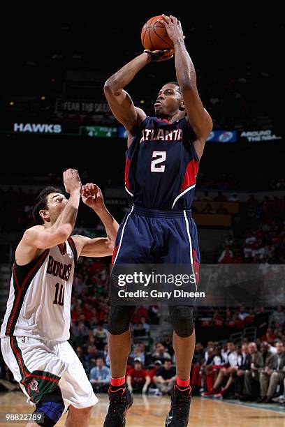 Joe Johnson of the Atlanta Hawks goes up for a shot over Carlos Delfino of the Milwaukee Bucks in Game Six of the Eastern Conference Quarterfinals...