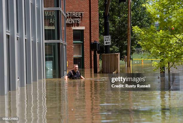 Michael Bunch wades on a flooded downtown sidewalk in Nashville, Tennessee Monday May 3, 2010. More than 13 inches of rainfall fell over two days...