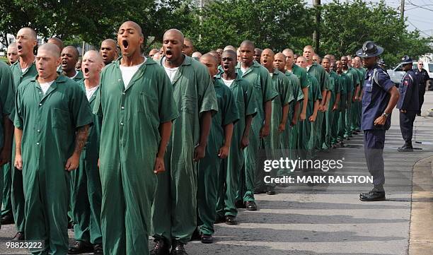 Prisoners from the Elayn Hunt Correctional Center line up as they prepare to undertake a training exercise to learn how to cleanse oil from birds...