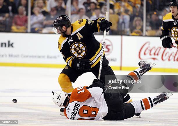 Patrice Bergeron of the Boston Bruins and Mike Richards of the Philadelphia Flyers fight for the puck in Game Two of the Eastern Conference...