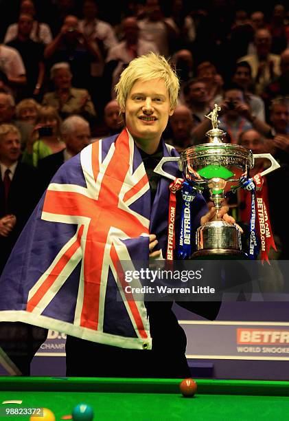 Neil Robertson of Australia poses with the trophy after beating Graeme Dott of Scotland during the final of the Betfred.com World Snooker...