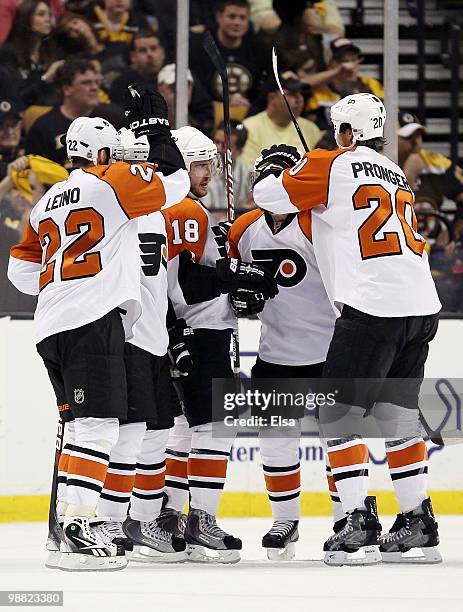 Mike Richards of the Philadelphia Flyers is congratulated by teammates Chris Pronger, Ville Leino and Danny Briere after Richards scored a goal in...