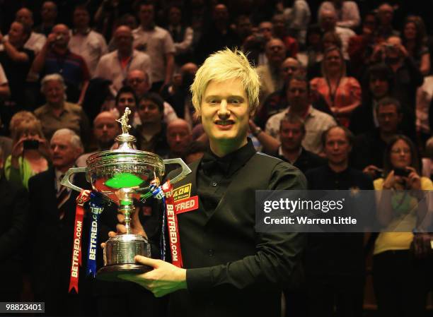 Neil Robertson of Australia poses with the trophy after beating Graeme Dott of Scotland during the final of the Betfred.com World Snooker...