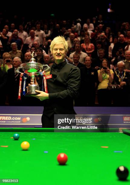 Neil Robertson of Australia poses with the trophy after beating Graeme Dott of Scotland during the final of the Betfred.com World Snooker...