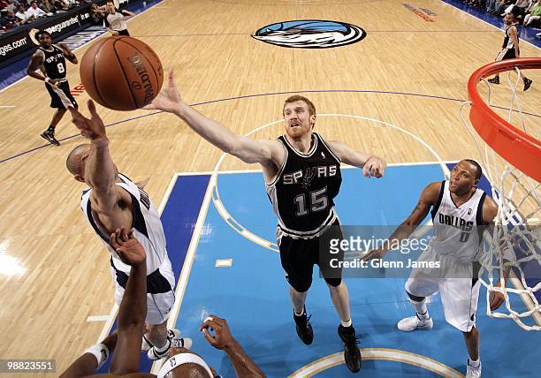 Matt Bonner of the San Antonio Spurs rebounds against Jason Kidd and Shawn Marion of the Dallas Mavericks during the game at American Airlines Center...