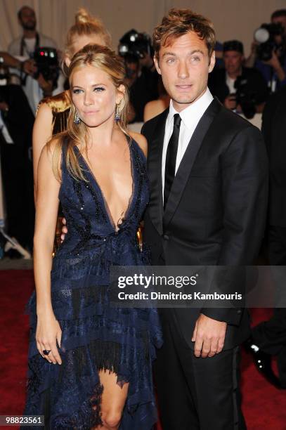 Actress Sienna Miller and actor Jude Law attend the Costume Institute Gala Benefit to celebrate the opening of the "American Woman: Fashioning a...