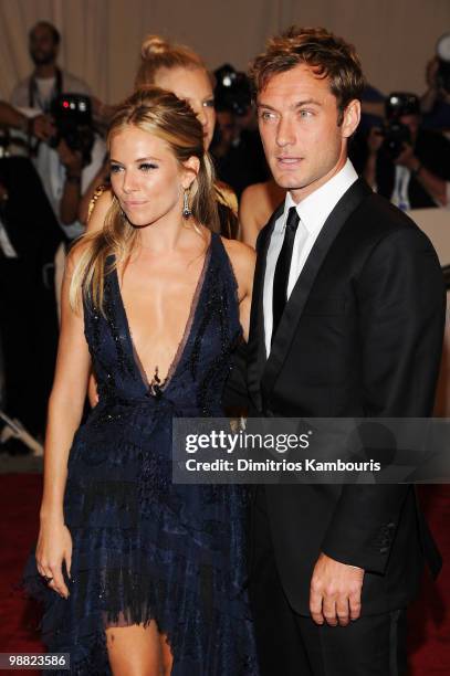 Actress Sienna Miller and actor Jude Law attend the Costume Institute Gala Benefit to celebrate the opening of the "American Woman: Fashioning a...