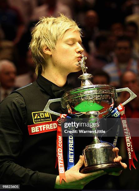 Neil Robertson of Australia poses with the trophy after beating Graeme Dott of Scotland during the final of the Betfred.com World Snooker...