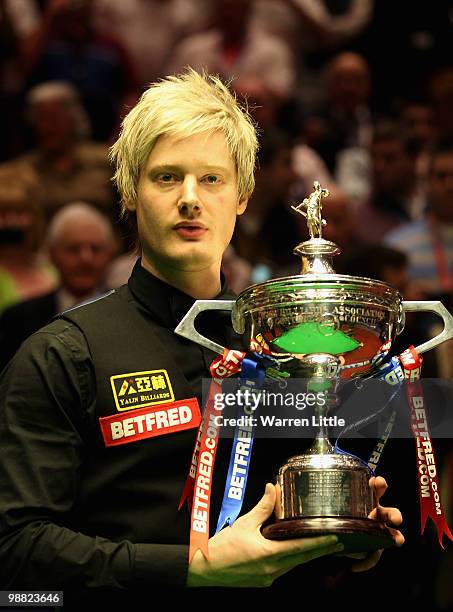 Neil Robertson of Australia poses with the trophy after beating Graeme Dott of Scotland during the final of the Betfred.com World Snooker...