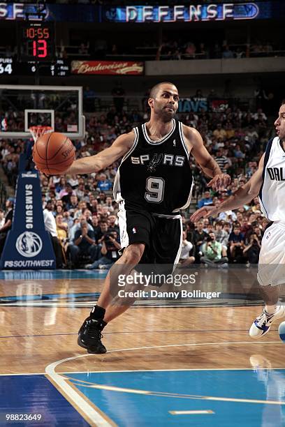 Tony Parker of the San Antonio Spurs drives to the basket against Jose Barea of the Dallas Mavericks during the game at American Airlines Center on...