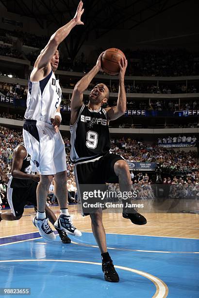 Tony Parker of the San Antonio Spurs goes up for a shot against Jason Kidd of the Dallas Mavericks during the game at American Airlines Center on...