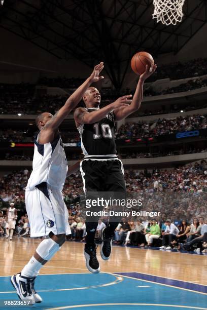 Keith Bogans of the San Antonio Spurs shoots a layup against Caron Butler of the Dallas Mavericks during the game at American Airlines Center on...