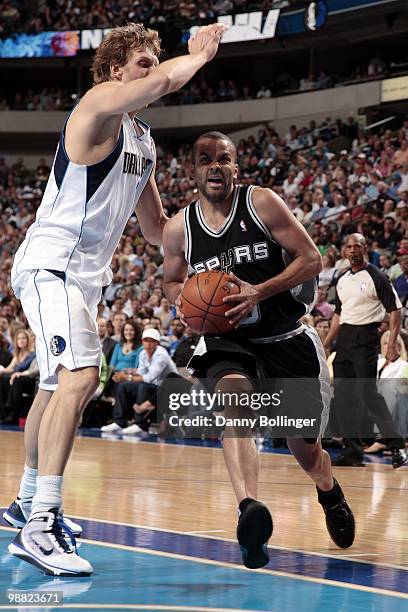 Tony Parker of the San Antonio Spurs drives to the basket against Dirk Nowitzki of the Dallas Mavericks during the game at American Airlines Center...