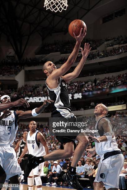 Tony Parker of the San Antonio Spurs drives to the basket for a layup against Jason Terry and Jason Kidd of the Dallas Mavericks during the game at...