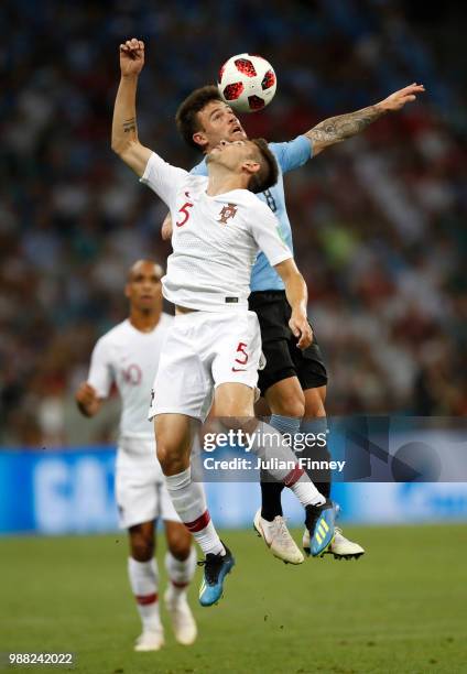 Nahitan Nandez of Uruguay wins a header over Raphael Guerreiro of Portugal during the 2018 FIFA World Cup Russia Round of 16 match between Uruguay...