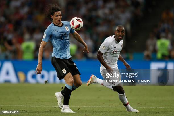Portugal's defender Ricardo Pereira vies for the ball with Uruguay's forward Edinson Cavani during the Russia 2018 World Cup round of 16 football...