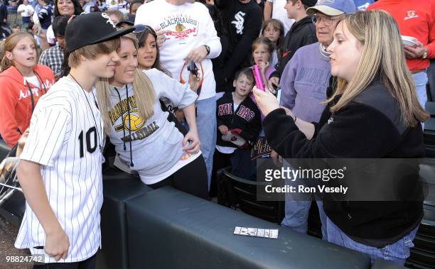 Pop star Justin Bieber greets fans after throwing out a ceremonial first pitch prior to the game between the Chicago White Sox and Kansas City Royals...