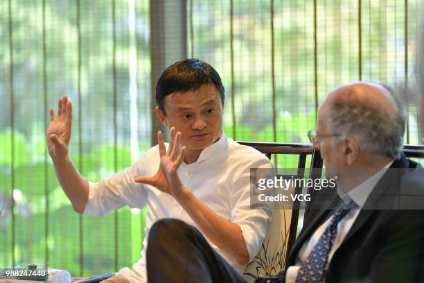 Alibaba chairman Jack Ma discusses with Nobel Prize in Economics 2011 laureate Thomas Sargent during the establishment ceremony of Alibaba's Luohan...