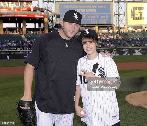 Pop star Justin Bieber poses for a picture with Mark Buehrle of the Chicago White Sox after throwing out a ceremonial first pitch prior to the game...