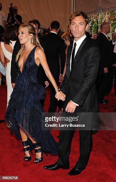Actors Sienna Miller and Jude Law attend the Costume Institute Gala Benefit to celebrate the opening of the "American Woman: Fashioning a National...