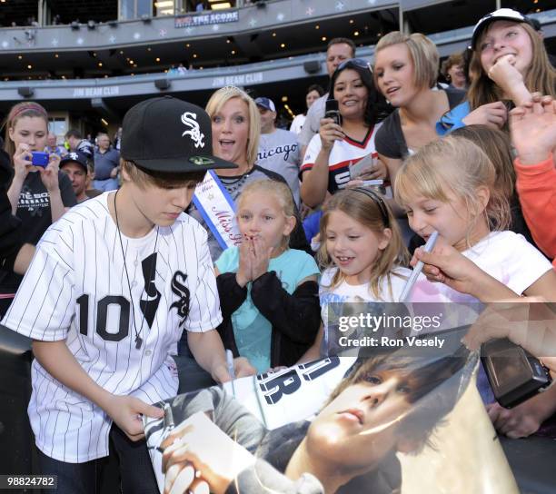 Pop star Justin Bieber greets fans after throwing out a ceremonial first pitch prior to the game between the Chicago White Sox and Kansas City Royals...