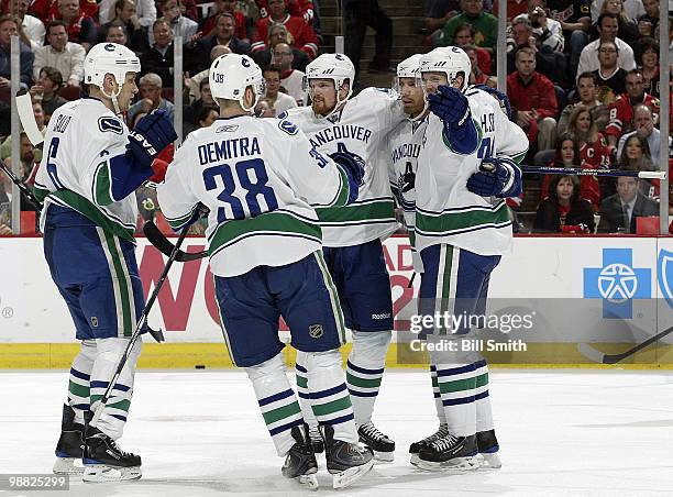 Sami Salo, Pavol Demitra, Daniel Sedin, Mikael Samuelsson, and Henrik Sedin of the Vancouver Canucks celebrate their second goal of the night against...