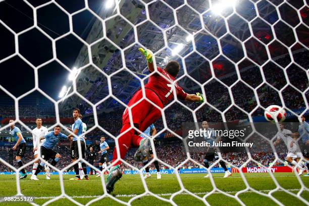 Pepe of Portugal scores his team's first goal past Fernando Muslera of Uruguay during the 2018 FIFA World Cup Russia Round of 16 match between...