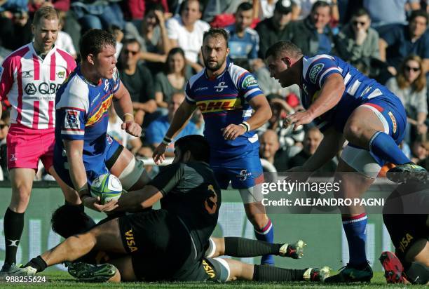 South Africa's Stormers lock Cobus Wiese is tackled by Argentina's Jaguares prop Nahuel Tetaz Chaparro during their Super Rugby match at Jose...