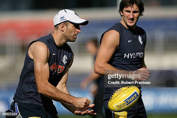 Chris Judd handballs during a Carlton Blues AFL training session at Visy Park on May 4, 2010 in Melbourne, Australia.