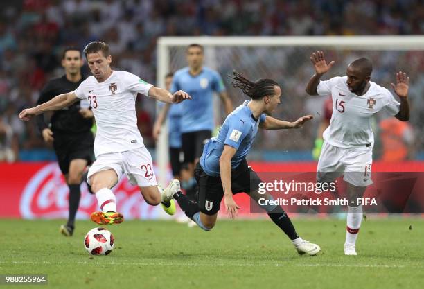 Adrien Silva and Ricardo of Portugal put prssure on Diego Laxalt of Uruguay during the 2018 FIFA World Cup Russia Round of 16 match between Uruguay...