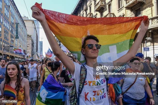 Members of the LGBT carry a flag in rainbow colors during the Gay Pride on June 30, 2018 in Milan, Italy. Manifestation the day of the pride LGTB for...