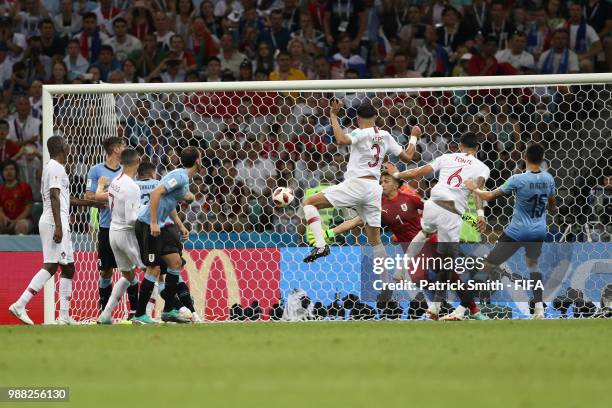 Pepe of Portugal scores his team's first goal past Fernando Muslera of Uruguay during the 2018 FIFA World Cup Russia Round of 16 match between...