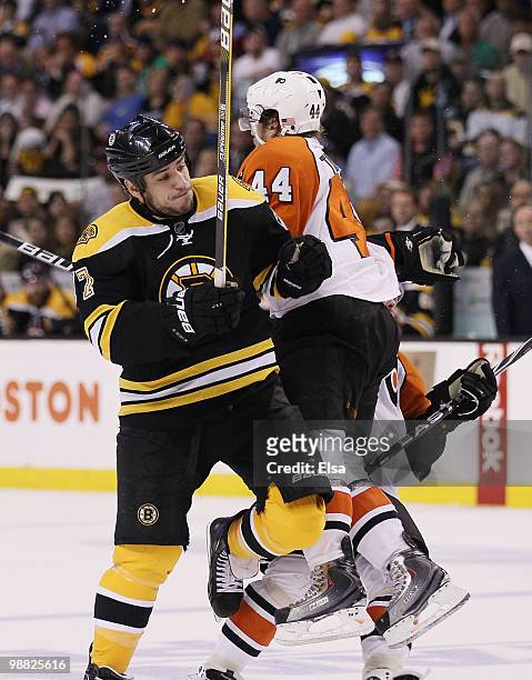 Milan Lucic of the Boston Bruins collides with Kimmo Timonen of the Philadelphia Flyers in Game Two of the Eastern Conference Semifinals during the...