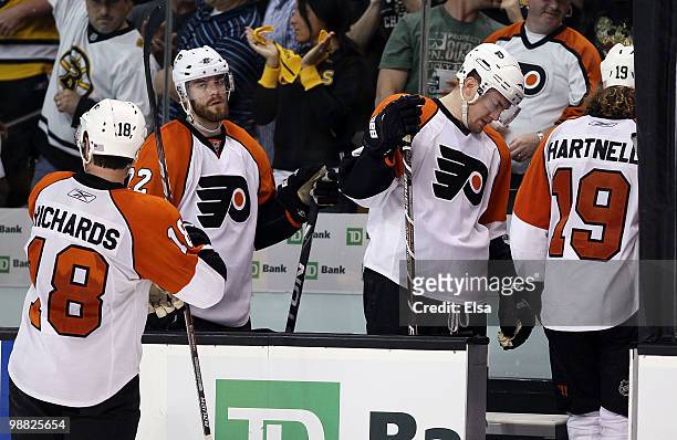 Scott Hartnell, James van Riemsdyk, Ville Leino and Mike Richards of the Philadelphia Flyers head into the locker room after losing to the Boston...