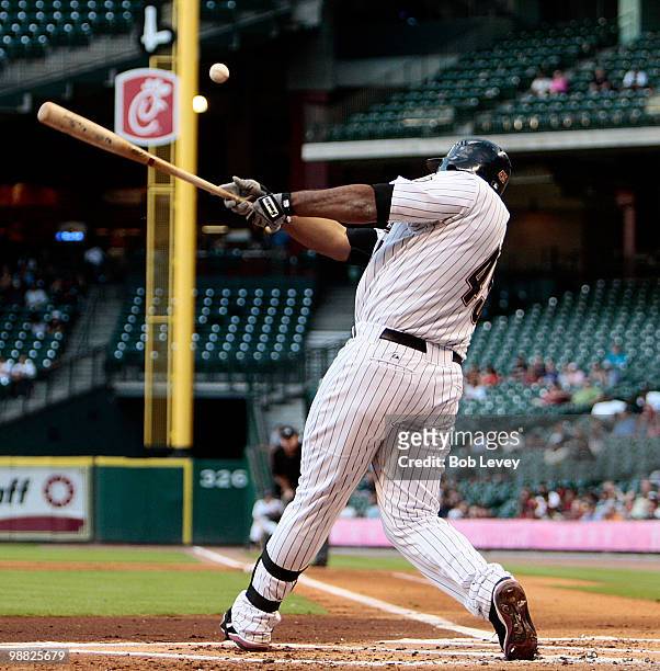 Carlos Lee of the Houston Astros doubles down the first baseline scoring Michael Bourn in the first inning against the Arizona Diamonbacks on May 3,...