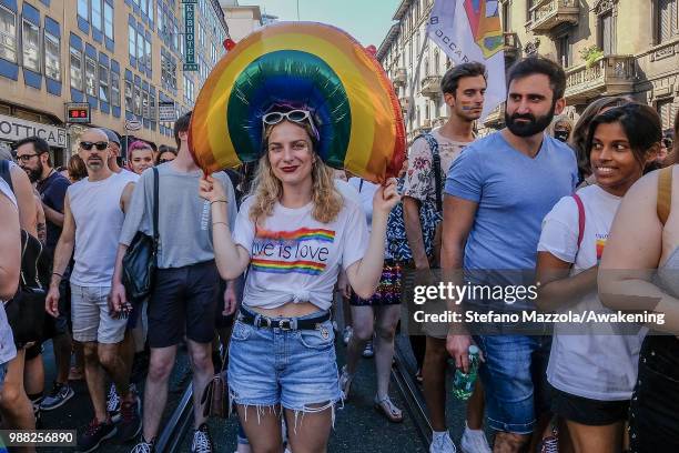 Members of the LGBT carry a hair in rainbow colors during the Gay Pride on June 30, 2018 in Milan, Italy. Manifestation the day of the pride LGTB for...