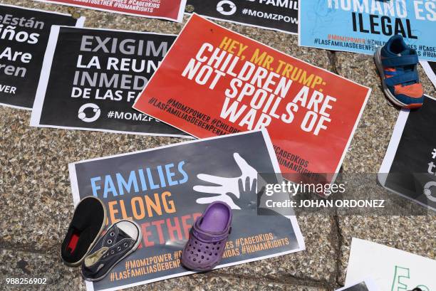 View of signs during a protest against US immigration policies outside the US embassy in Mexico City on June 30, 2018. - Three undocumented migrant...