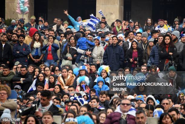 Fans of Uruguay attend the broadcasting of the Russia 2018 FIFA World Cup football match Uruguay against Portugal in a huge screen downtown...