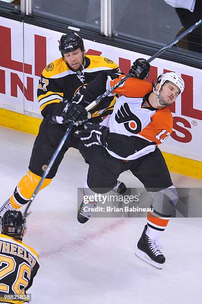 Steve Begin of the Boston Bruins checks Daniel Carcillo of the Philadelphia Flyers in Game Two of the Eastern Conference Semifinals during the 2010...