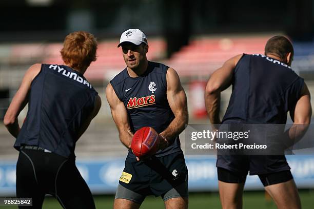 Chris Judd handballs during a Carlton Blues AFL training session at Visy Park on May 4, 2010 in Melbourne, Australia.