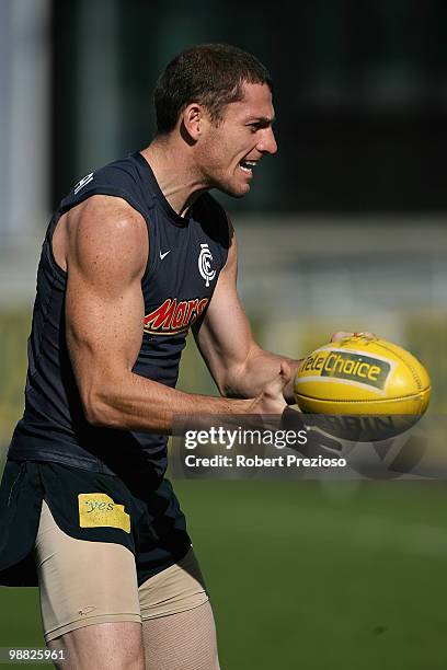 Heath Scotland handballs during a Carlton Blues AFL training session at Visy Park on May 4, 2010 in Melbourne, Australia.