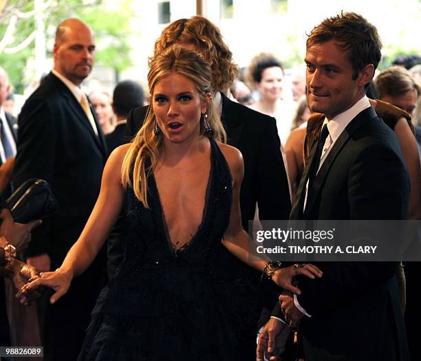 Actors Sienna Miller and Jude Law attend the Costume Institute Gala Benefit to celebrate the opening of the 'American Woman: Fashioning a National...