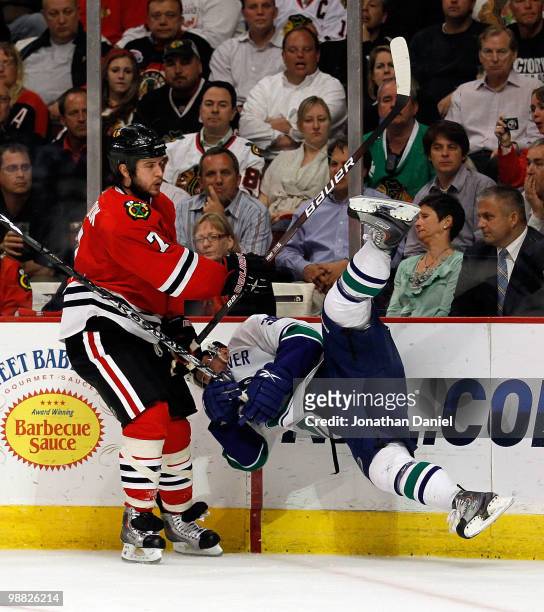 Brent Seabrook of the Chicago Blackhawks upends Jannik Hansen of the Vancouver Canucks in Game Two of the Western Conference Semifinals during the...