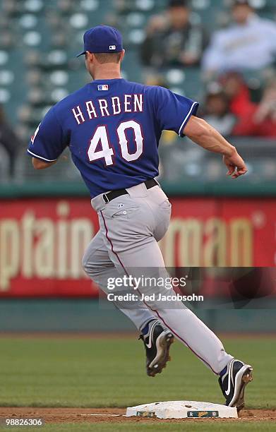 Rich Harden of the Texas Rangers commits an error by missing first base against the Oakland Athletics on a ball hit by Eric Chavez in the second...