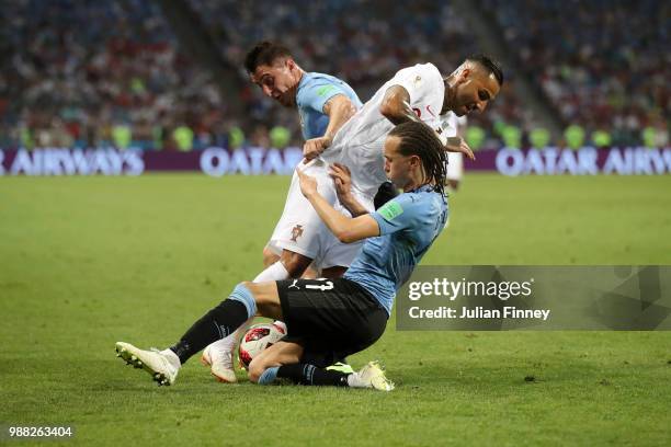 Ricardo Quaresma of Portugal is tackled by Diego Laxalt and Cristian Rodriguez of Uruguay during the 2018 FIFA World Cup Russia Round of 16 match...
